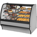 Bakery display case with various pastries and cakes on a white background