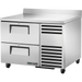 Stainless steel refrigerator with two doors and a freezer drawer on a white background